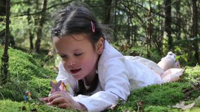 Little Girl Playing With Enchanted Fairies In The Woods