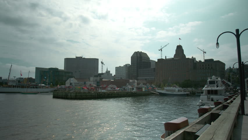 Downtown Halifax, Nova Scotia skyline with the harbor and boats in the foreground.
