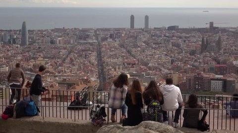 BARCELONA, SPAIN - FEBRUARY 26, 2016: Unidentified young people enjoy aerial Barcelona from top point, observation deck at Guinardo hill. Former military structure Bateria Anti-aerea Turo de la Rovira
