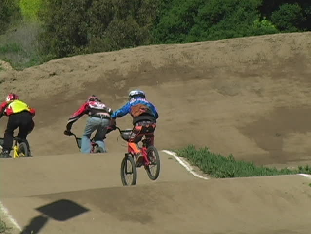 A view of a BMX racer going down the track.