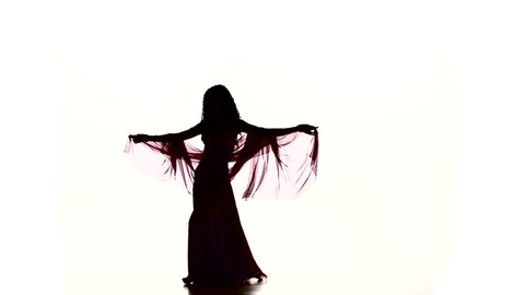 Pretty young girl go on dancing belly dance with colored shawl, on white, slow motion