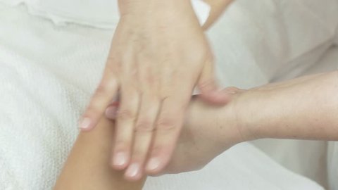 Close up of cosmetologist hands waxing wrist of girl hand in beauty saloon. Cosmetic procedure
