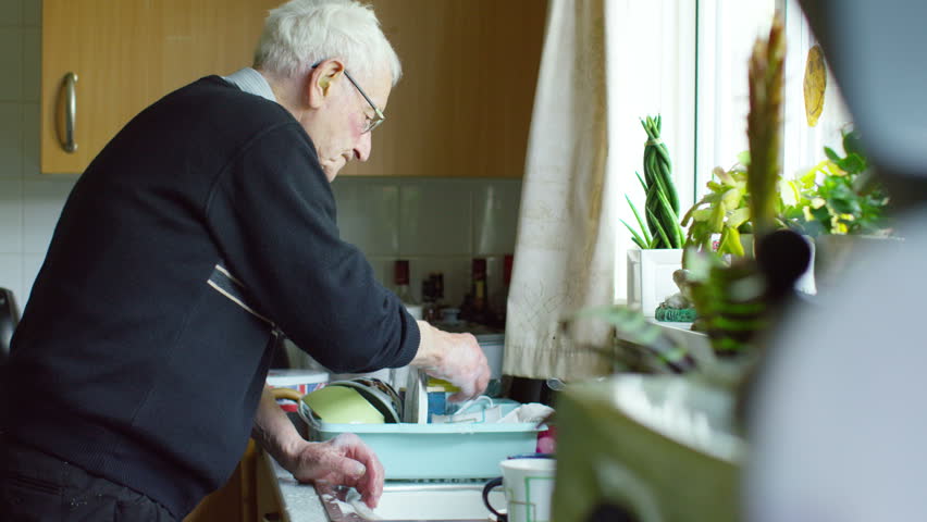 4K Elderly man doing washing up at home. UK -- August, 2015 Royalty-Free Stock Footage #15124867