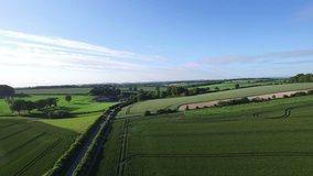 4K Aerial flight above agricultural area and greenery in the countryside UK -- July, 2015