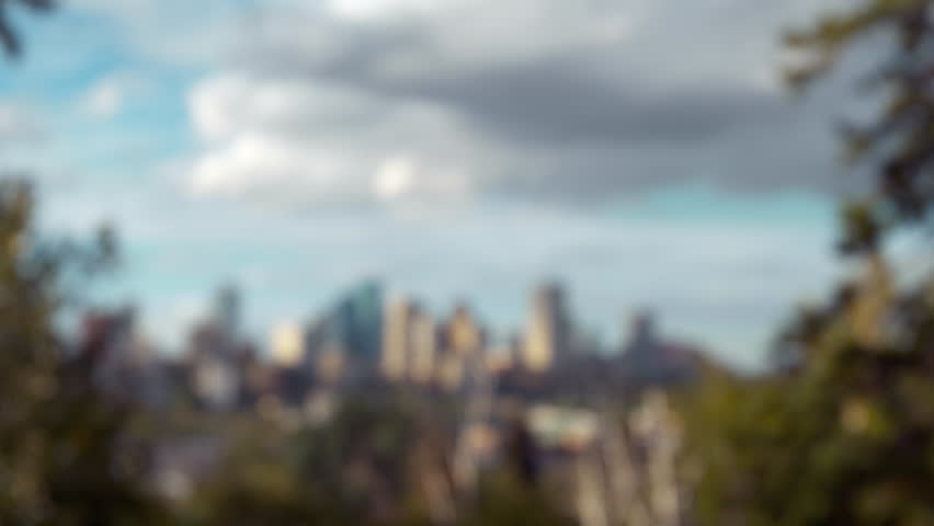 Shot of the capital city of Edmonton in Alberta, Canada.  Skyline shot of downtown framed by trees on either side of the frame.