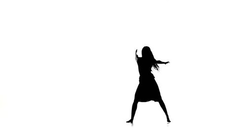 Graceful girl with long hair dance modern contemporary style and jumps on white, silhouette, slow motion