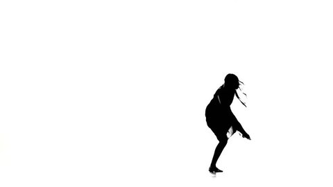 Graceful girl dancer dancing contemporary dance, jumps on white, silhouette, slow motion