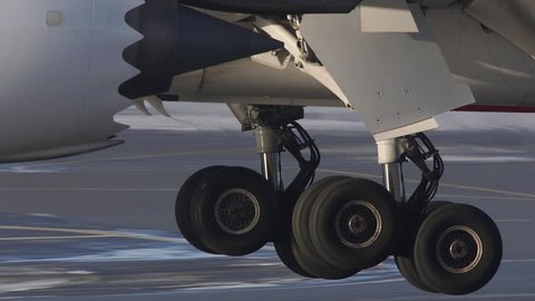 HUGE AIRPLANE DETAIL LANDING GEAR TOUCHDOWN - CA DECEMBER 2016: airplane landing on runway close up of gear touchdown