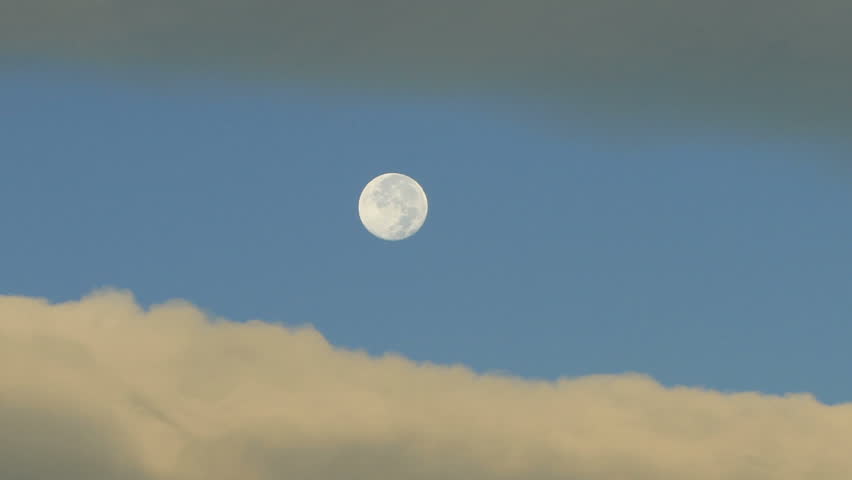 Full moon in the evening sky with bands of clouds. HD 1080p timelapse.