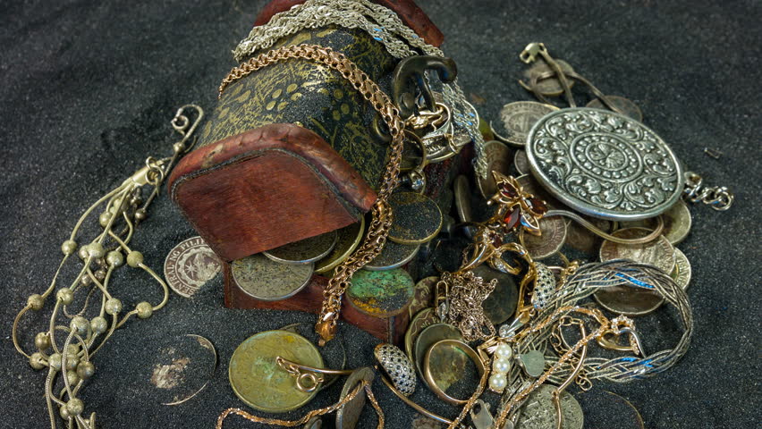 Small pirate treasure chest closeup rotation on a black sand.