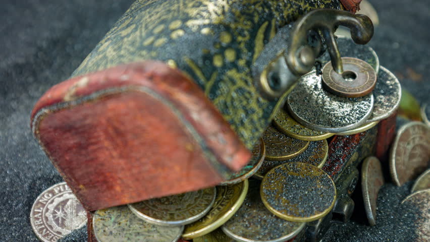 The antiquarian wooden chest with coins closeup rotation on a black sand. 