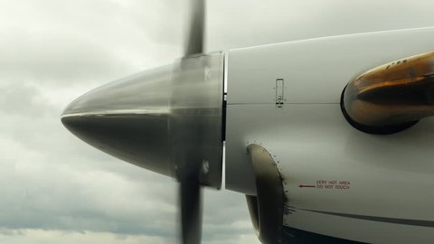 Airplane Propeller Spinning Down to Stop, Wide from Side