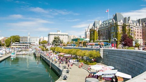 VICTORIA BC, CANADA - 2016: Panning Across the Victoria British Columbia Inner Harbour Waterfront from the Marina to the Fairmont Empress Hotel with Sightseeing Tourists