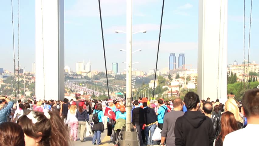 ISTANBUL - OCTOBER 17: Crowd of people walk from Asia to Europe on Bosporus