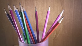 black lead pencils with bright coloring of wooden part turn in a glass