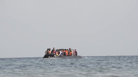 LESVOS, GREECE March 03, 2016: Refugees arriving in Greece in dinghy boat from Turkey. These Syrian, Afghanistan and African refugees land their boat at the coast of Lesvos near Mytilene.
