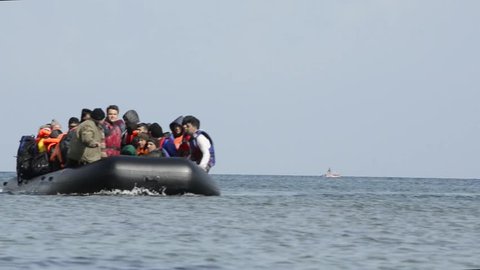 LESVOS, GREECE March 03, 2016: Refugees arriving in Greece in dinghy boat from Turkey. These Syrian, Afghanistan and African refugees land their boat at the coast of Lesvos near Mytilene.