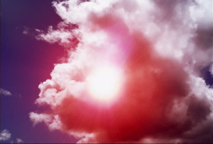 Purple sun flare against cloudy background