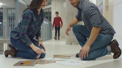 Young man helps a student by picking up her papers from the floor. They meet each other eyes and fall in love at first sight. Shot on RED Cinema Camera in 4K (UHD).