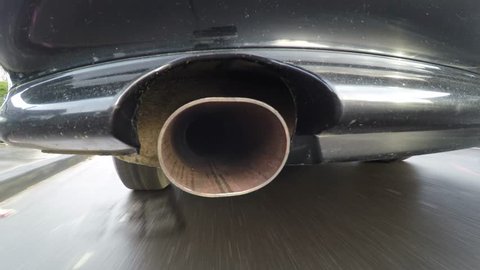 Car with pollution of the exhaust pipe. On-board-camera at a car in the fume of the exhaust pipe
