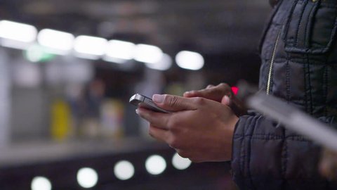 4k Close up of hands using mobile phones on subway train platform