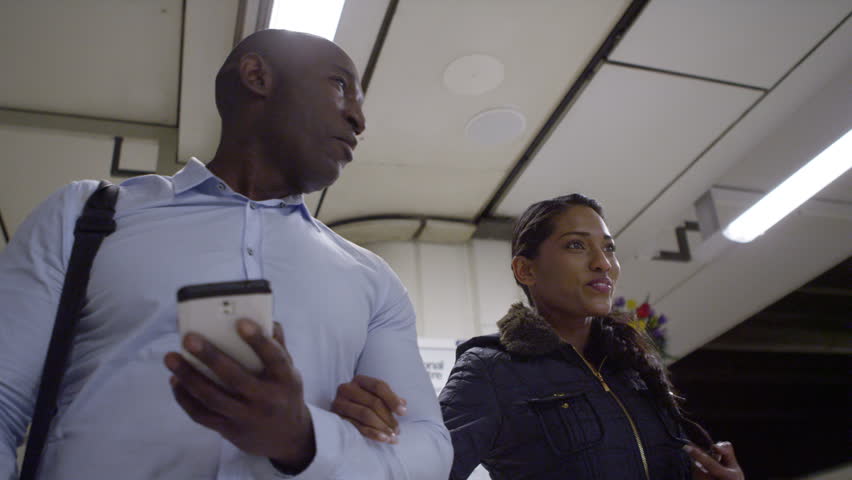 4k, happy African american tourists walking through subway underground station