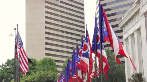 Ohio flags flying outside of Ohio Statehouse. USA flag in the background.