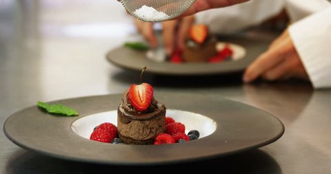 Chefs putting finishing touch on desserts in slow motion Stock Video