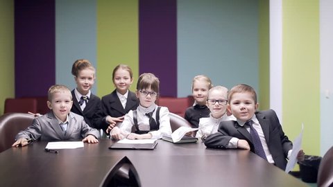 kids throw documents in air at business meeting