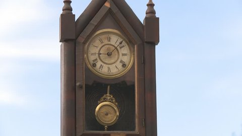 Old clock pendulum on the sky time concept
