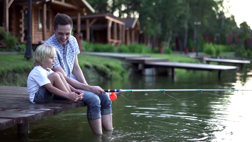 Dad and son fishing outdoors