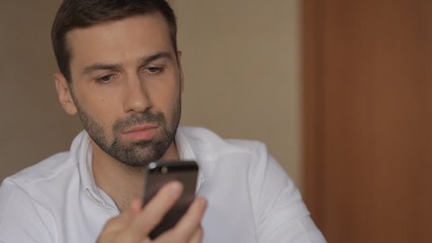 A young man is using a mobile phone