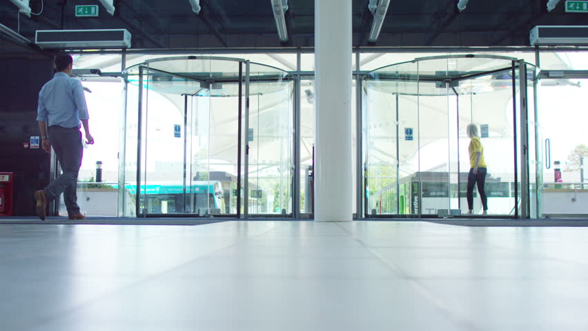 4K Diverse business team walking through lobby area of modern office building