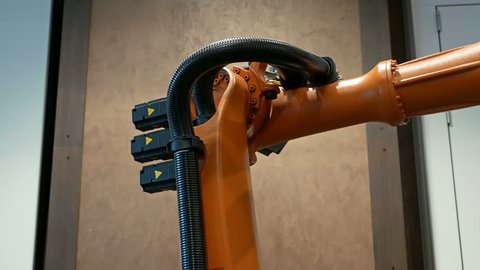 Industrial robotics robot arm for welding and assembling with three dimensional 3d freedom movement. Modern technology 4K UHD video footage.