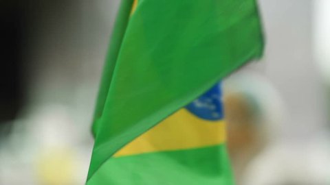 SAO PAULO, BRAZIL - MARCH 13, 2015: Large crowds of people protesting against Brazilian corruption and wanting the impeachment of president Dilma Rousseff. Brazilian flag being waved