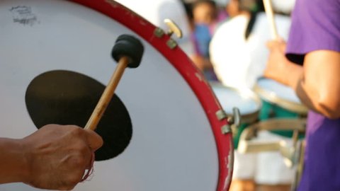 A man playing the drum with the bands
