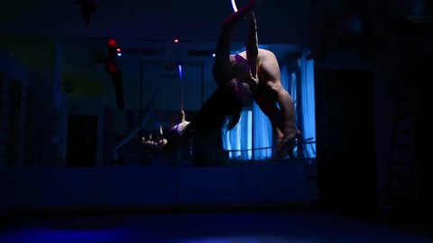  Aerial acrobat woman on circus stage. tricks hoop on a blue background