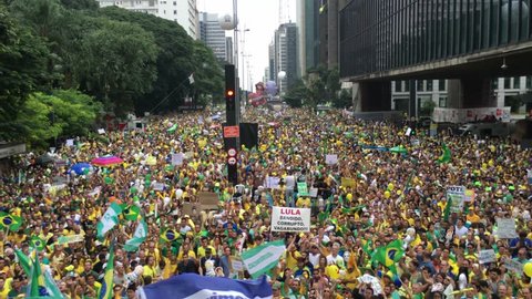 SAO PAULO, BRAZIL - MARCH 13, 2015: Large crowds of people protesting against Brazilian corruption and wanting the impeachment of president Dilma Rousseff and the removal of her political party PT. 4K