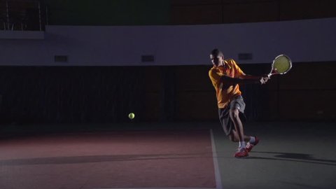 Backhand stroke in tennis. Spectacular shot in slow motion. Professional lighting