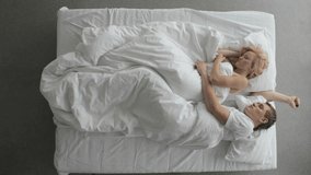Young couple sleeping and turning in bed at night 