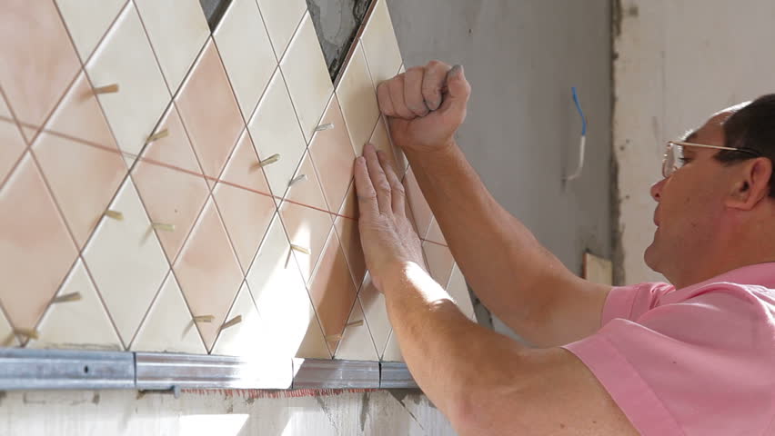 Worker Installing Tiles Kitchen Wall, How To Install Ceramic Tile On A Kitchen Wall