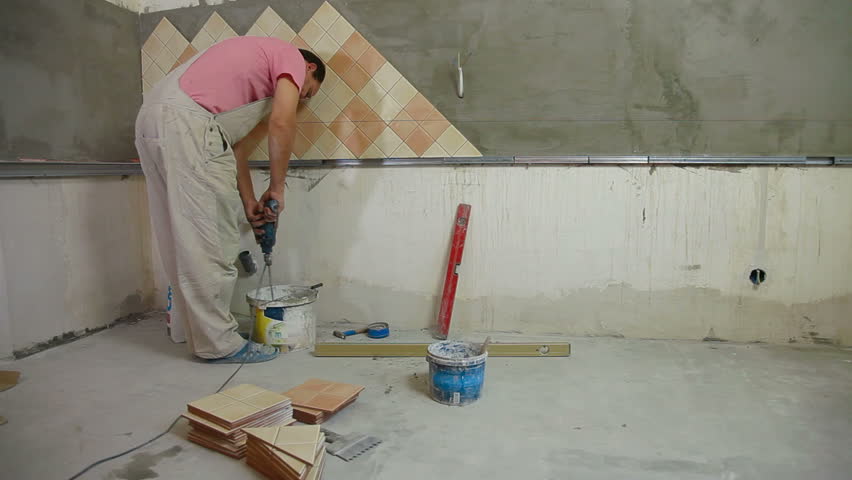Man Installs Ceramic Tile Stock, Mixing Grout For Floor Tile