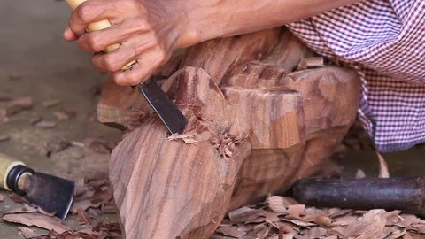  Burmese man are making wooden souvenirs for tourists in Bagan, Myanmar. Wood Carving is a traditional handicraft in Myanmar