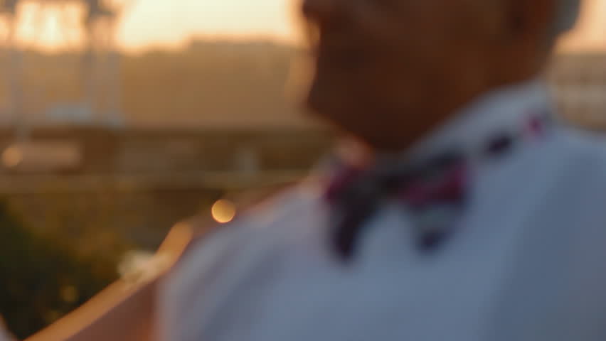 Well dressed old man with bow tie  kiss his woman.Closeup portrait. Slow motion.