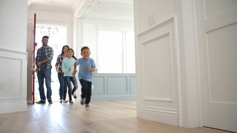 Slow Motion Shot Of Hispanic Family Moving Into New Home 
