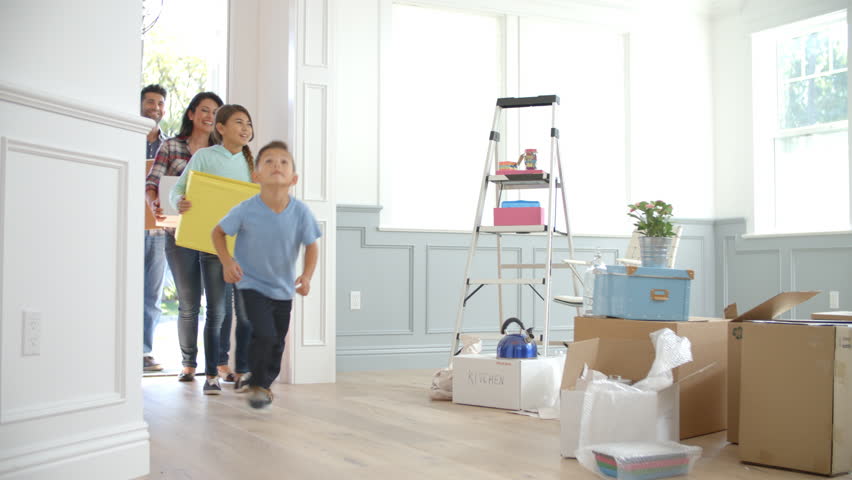 Slow Motion Shot Of Hispanic Family Moving Into New Home 