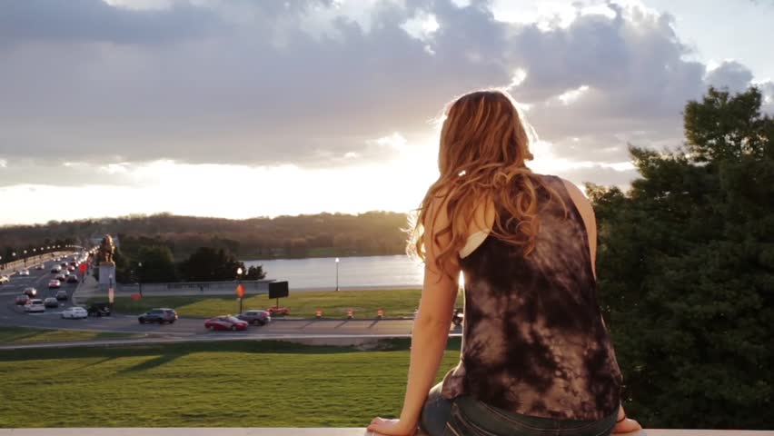 Teen girl watching sunset from Lincoln Memorial in Washington, DC