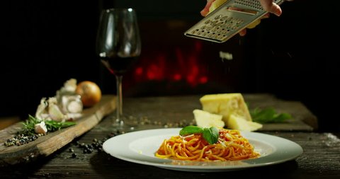 beautiful italian pasta composition in old traditional cottage with fireplace and relax atmosphere with chef garnish plate with parmesan cheese and basil leafs ஸ்டாக் வீடியோ