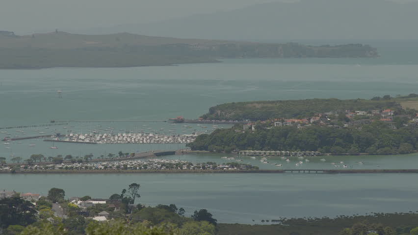 Auckland, New-Zealand - CIRCA December 2013: Coastal view of islands on the water with lots houses and buildings. Mountain in the background.   