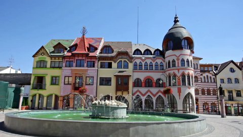 KOMARNO, SLOVAKIA - JULY 23, 2013: General view of Komarno town centre and playing fountain on Europe Square in summer day.